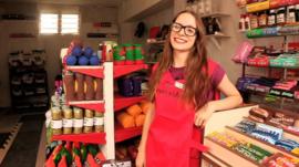 Lucy Sparrow in her corner shop selling felt goods