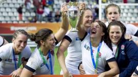 England's players celebrate with the Rugby World Cup trophy