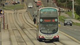 Bus running between guide rails
