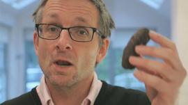 Michael Mosley with a blood sausage