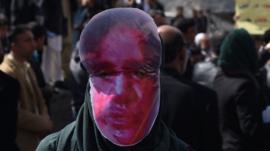 Protesters wore masks meant to show the bloodied face of Farkhunda