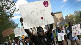 Students from Digital Harbor High School chant 'We Love Baltimore' as they march outside City Hall April 29, 2015 in Baltimore, Maryland