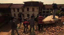 People digging through the rubble