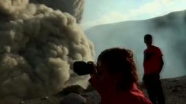 People pointing cameras at cloud of ash