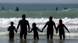 Family in water at Newquay beach