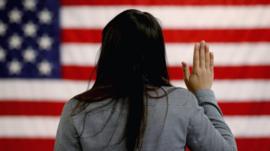 A woman takes part in a US naturalisation ceremony