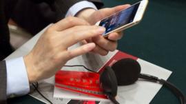 A Chinese Communist party cadre checks his mobile phone