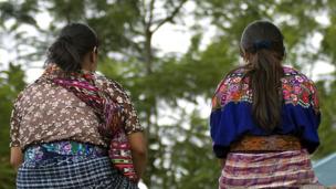 Guatemalan women sitting on a wall