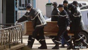 Rescue workers carry the coffin of one of the hostages killed during a hostage crisis in a gas plant at the hospital in In Amenas, 21 January 2013.