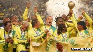 The Mamelodi Sundowns players pose with the Trophy after winning the final during the SAA Supa 8 Final match between the Mamelodi Sundowns and the Orlando Pirates at the Absa Stadium in September 2007 in Durban, South Africa