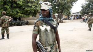 Congolese M23 rebels stand on a street in Rutshuru, Democratic Republic of Congo 3 August, 2013.