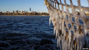 Ice forms on the shore of the East River due to unusually low temperatures caused by a Polar Vortex in New York