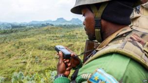 A Congolese army soldier looks at a GPS device on 15 June 2014 near Kanyesheza hill, near the border with Rwanda - 15 June 2014