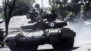 Pro-Russian militants sit on a tank in Donetsk, eastern Ukraine