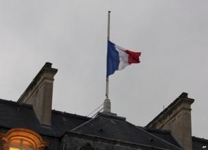 The French flag flies at half-mast over the Elysee Palace in Paris, 8 January