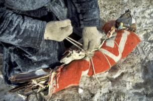 Herder Shohan wraps up his golden eagle for the cold five-day journey - copyright Timothy Allen