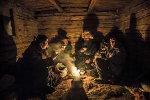 Herders keep warm in a hut on their mountainous migration route - copyright Timothy Allen