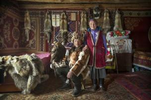 Nomadic Kazakh herder Shohan, with his wife and golden eagle - copyright Timothy Allen