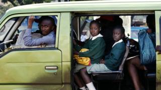 kenyan children going to scholl in a matatatu