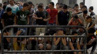 This file photo taken on September 22, 2016 shows survivors from a boat that capsized, off Egypt"s north coast are seen in a police station in Rashid in northern Egypt.