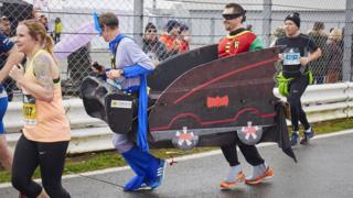 Runners dressed as Batmobile