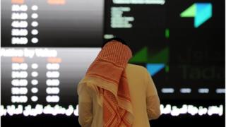 A Saudi investor monitors the Saudi Stock Exchange