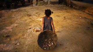 An Indian child works near her parents at a construction project in front of the Jawaharlal Nehru Stadium on January 30, 2010 in New Delhi, India.