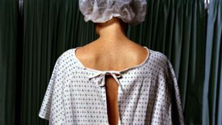 A woman in a surgical gown
