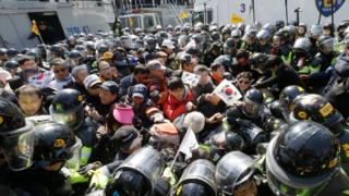 Supporters of South Korean President Park Geun-hye are blocked by police officers as they march toward Constitutional Court after a rally opposing her impeachment in Seoul, South Korea, Friday, March 10, 2017
