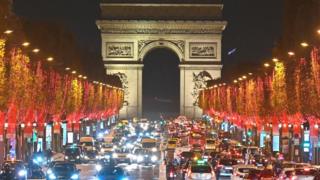 Christmas lights on the famous Avenue des Champs-Élysées - with the Arc de Triomphe, lit up in spotlights.