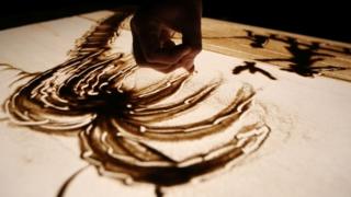 Egyptian artist Michael Romany creates sand drawing at his home on the outskirts of Cairo, Egypt - Friday 25 November 2016