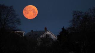 The moon sets over the Dorchester neighbourhood of Boston
