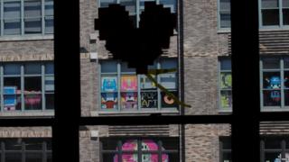 Heart made from sticky notes on window