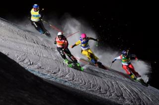 Tania Prymak of the USA, Marielle Thompson of Canada, Heidi Zacher of Germany, and Fanny Smith of Switzerland, from left, speed down the track during Ski Cross World Cup in Arosa, Switzerland