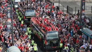 Fans watching the Wales football team on their open-top bus