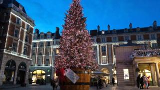 It's the UK next and to London, where a huge pink Christmas tree has gone up in Covent Garden