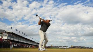 A golfer takes his tee shot