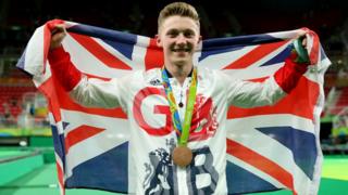 Nile Wilson poses for photographs after the medal ceremony for the Horizontal Bar