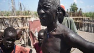 South Sudanese man whose home was burned by soldiers and militiamen.