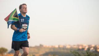 Comic Relief handout file photo of Eddie Izzard during marathon number ten of 27 in his gruelling Sport Relief challenge. The finish line is in sight as he prepares to reach Robben Island on the final leg of his challenge, that pays tribute to Nelson Mandela"s life.