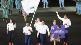 The parade of nations starts. The first 'nation' out is the Independent Paralympic Athletes, led by Syrian refugee Ibrahim Al Hussein.