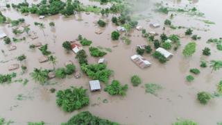 Aerial photographs show the extent of floods, the destruction of crops, homes and