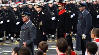 Prince Harry and William stand behind their father at the Cenotaph.