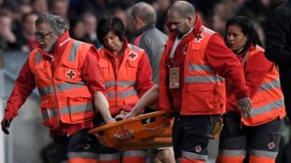 Arsenal's French defender Laurent Koscielny is carried on a stretcher during the UEFA Europa League semi-final second leg football match between Club Atletico de Madrid and Arsenal FC at the Wanda Metropolitano stadium in Madrid on May 3, 2018.