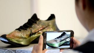 A person takes a photo of the Nike Vaporfly Elite Trainers