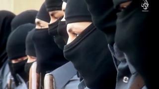 This image made from video posted online Sunday, Dec. 20, 2015, by supporters of the Tripoli Province of the Islamic State (IS) in Libya on a social media site, shows training of its "Islamic police" in Sirte, Libya