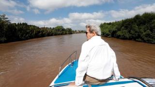 US Secretary of State John Kerry rides a boat in the Mekong Delta