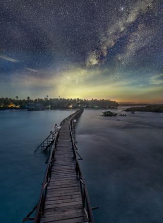 Images shows a pontoon under a starry sky