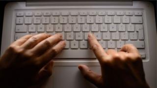 Man's hands on a keyboard