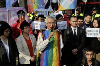 Veteran gay rights activist Chi Chia-wei (C) speaks to the press with his supporters in front of the Judicial Yuan in Taipei on 24 March 2017.